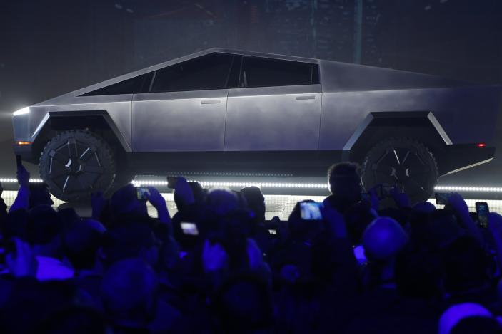 File - The Tesla Cybertruck is unveiled at Tesla's design studio on Nov. 21, 2019, in Hawthorne, Calif. Tesla CEO Elon Musk is expected to give an update on manufacturing problems with long-awaited Cybertruck at an event Thursday marking the first deliveries of the futuristic, angular pickup truck. (AP Photo/Ringo H.W. Chiu, File)