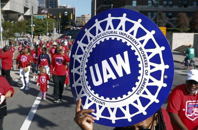 FILE - United Auto Workers members walk in the Labor Day parade, Sept. 2, 2019, in Detroit. The United Auto Workers union announced plans Wednesday, Nov. 29, 2023, to try to simultaneously organize workers at more than a dozen nonunion auto factories. (AP Photo/Paul Sancya, File)