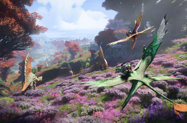 A blue humanoid Na'avi rides on the back of a flying creature over a colorful landscape as dinosaur-like creatures roam in Avatar: Frontiers of Pandora.