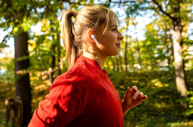 Young woman running in park.