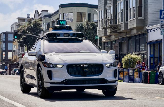 Waymo's autonomous vehicle driving on a street.                               