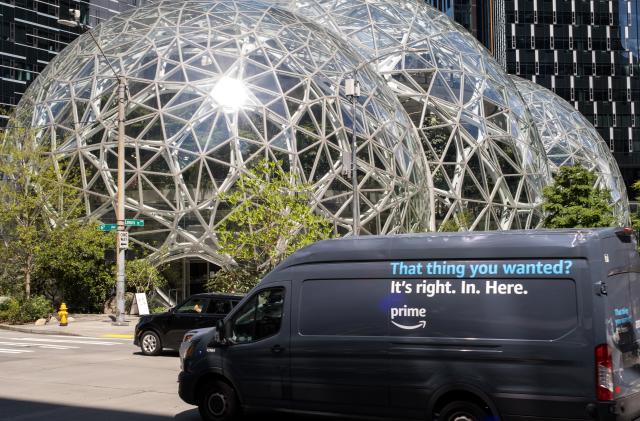 Seattle, USA - May 8, 2023: Late in the day an Amazon prime delivery truck passing by the Amazon HQ.